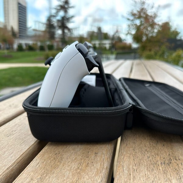 Side profile view of PlayStation Portal console propped up inside the open Vaultica case using the integrated kickstand flap for tabletop play on a wooden surface.